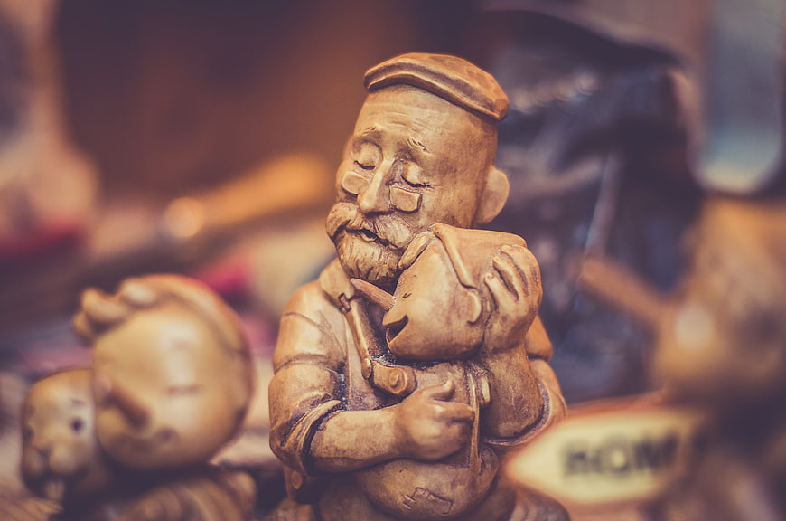 Wooden carving of father hugging child