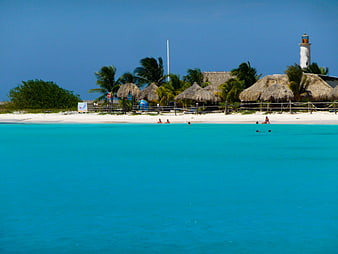 Tropical Beach with Turquoise Water and Thatched Huts
