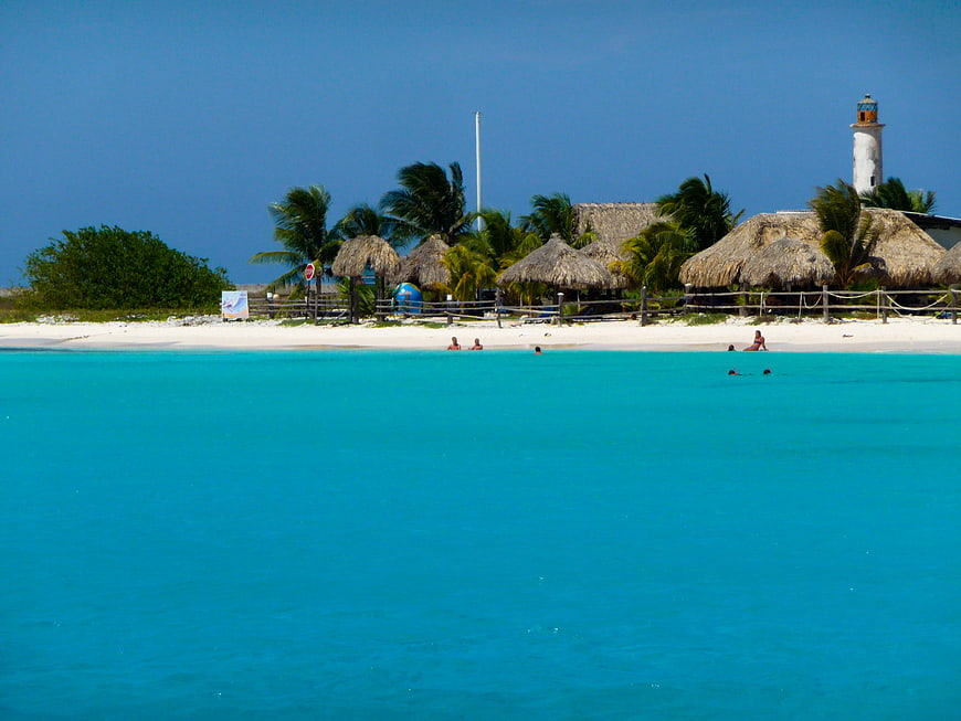 Tropical Beach with Turquoise Water and Thatched Huts