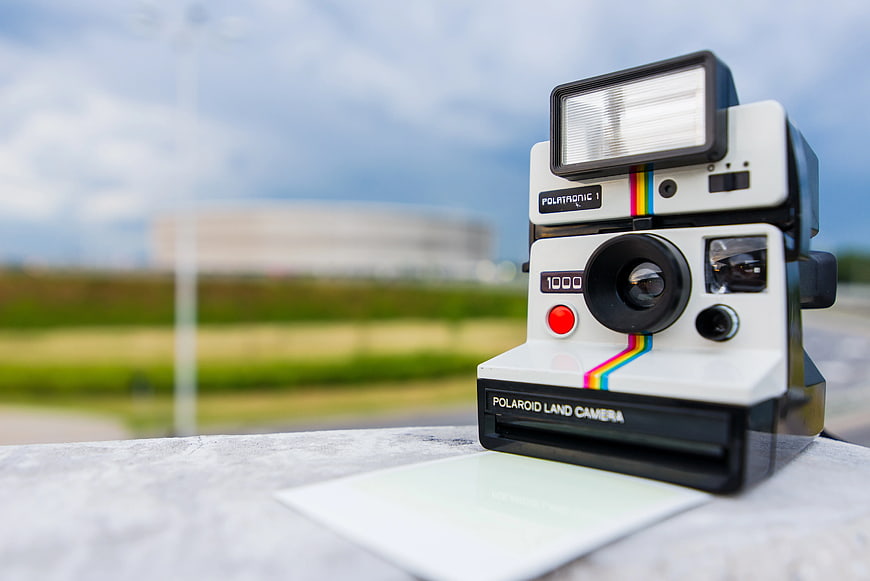 Vintage Polaroid Land Camera 1000 on Outdoor Table