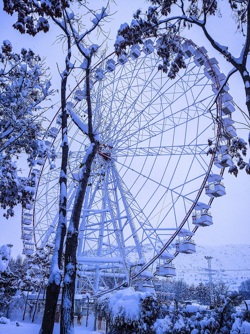 Snow-covered Ferris wheel in winter park