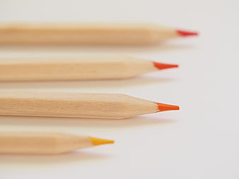 Close-up of wooden colored pencils on white background