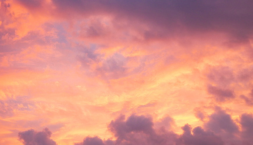 Vibrant Pink and Orange Sunset Sky with Clouds