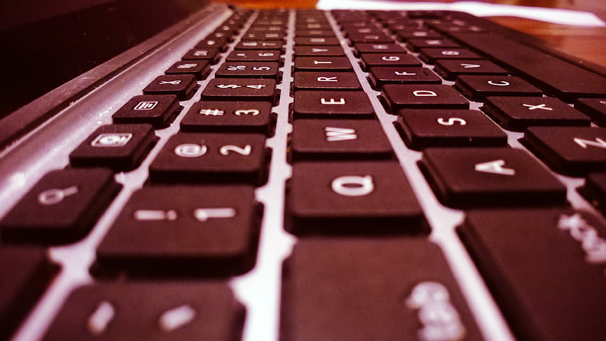 Close-up of black laptop keyboard with shallow depth of field