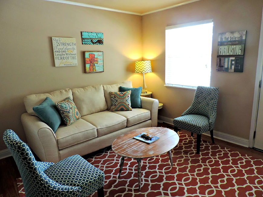 Cozy living room with beige sofa and patterned rug