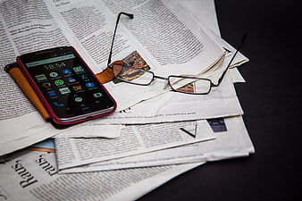 Smartphone and Glasses on Newspaper