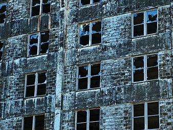 Weathered Brick Facade with Broken Windows