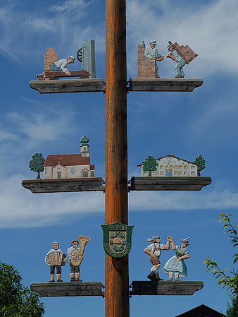 Traditional Bavarian Maypole with Carved Figures and Scenes