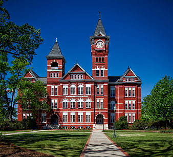 Red Brick Victorian Building with Clock Tower on Sunny Day