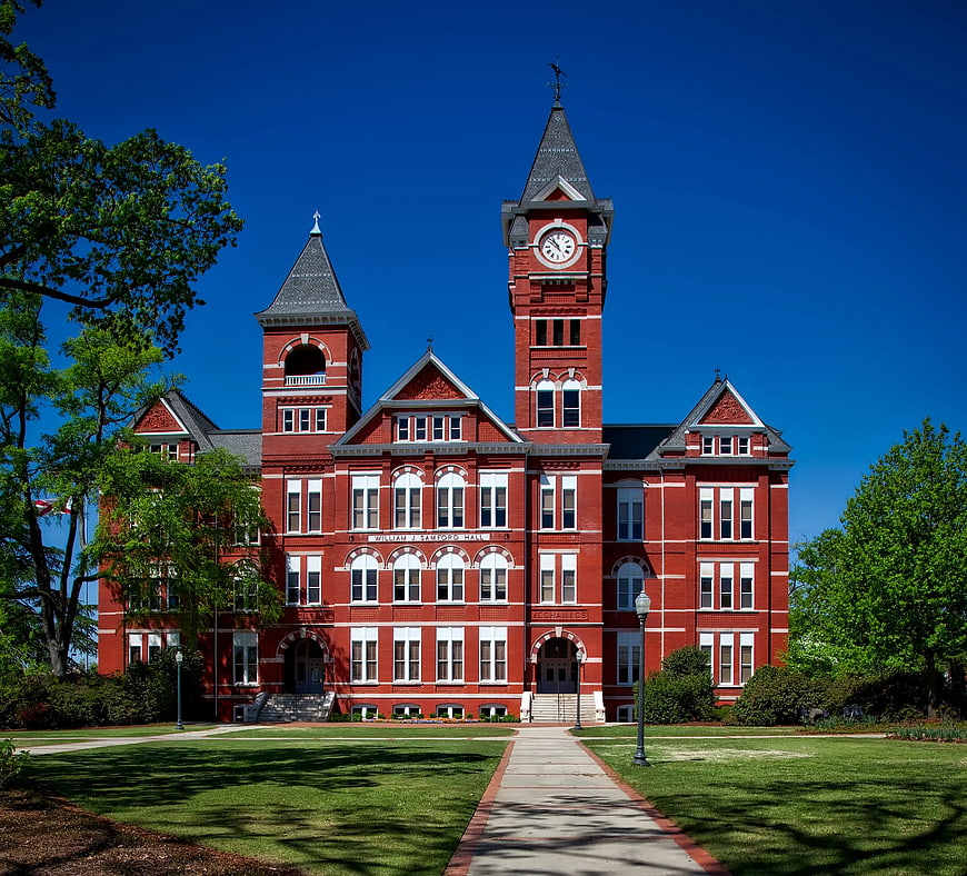 Red Brick Victorian Building with Clock Tower on Sunny Day