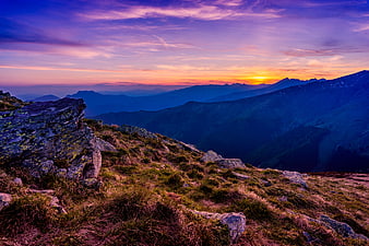 Dramatic Mountain Sunset with Purple Sky and Rocky Ridge