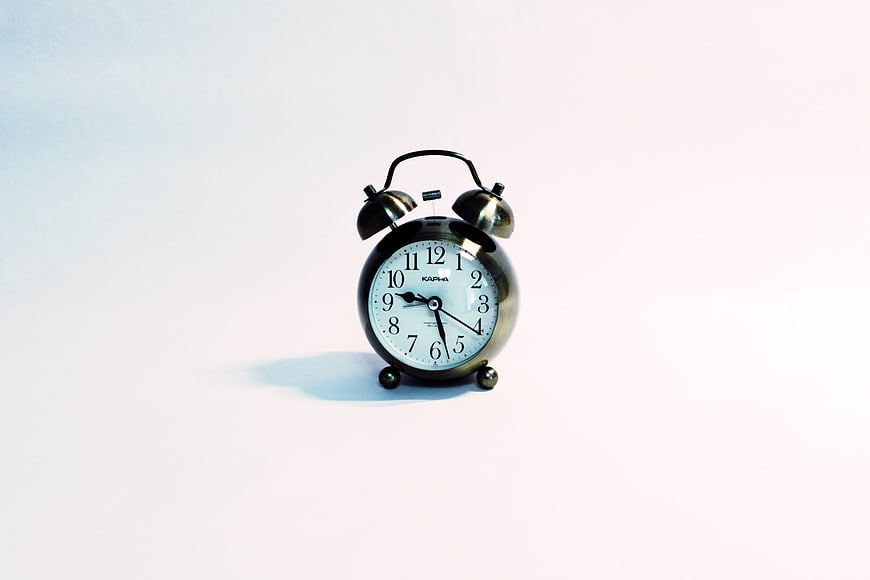 Classic Black Twin Bell Alarm Clock On White Background
