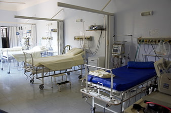 Empty hospital ward with medical beds and equipment