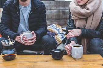 Couple drinking coffee outdoors in winter