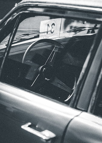Vintage car interior with steering wheel and racing number
