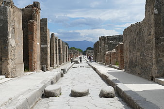Ancient Roman Street in Pompeii with Vesuvius in Background