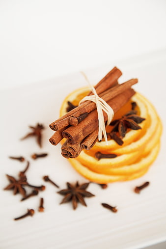 Cinnamon Sticks, Star Anise, and Orange Slices on White Background