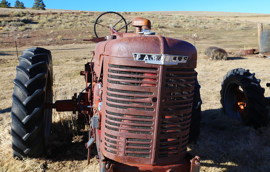 Vintage Rusty Farmall Tractor in Dry Field