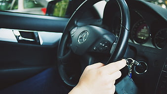 Hand turning key in Mercedes-Benz steering wheel ignition