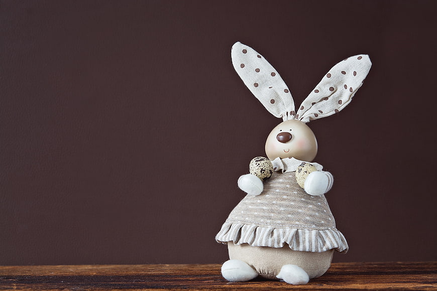 Cute Easter Bunny Decoration with Quail Eggs on Wooden Table