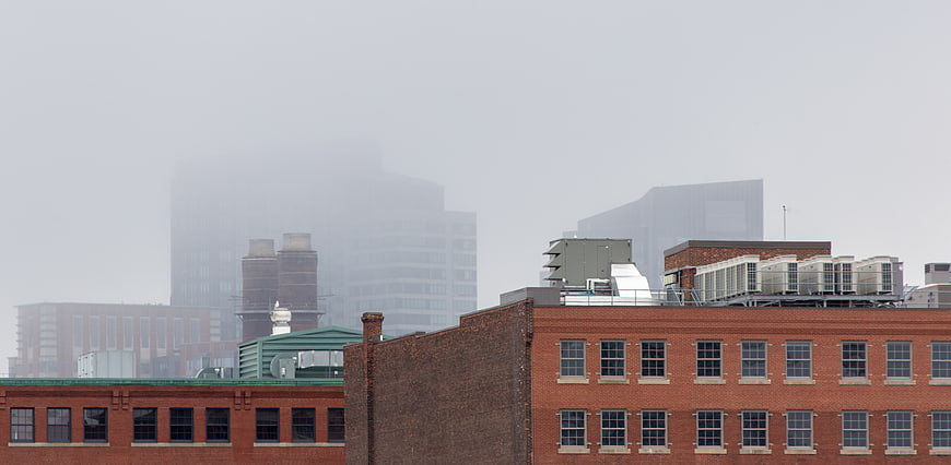 Foggy urban skyline with brick buildings and misty skyscrapers