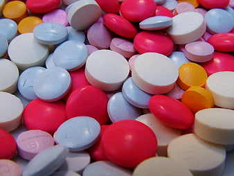 Colorful assortment of round pills and tablets close up
