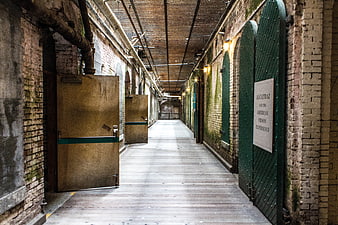 Alcatraz Prison Corridor with Green Cell Doors and Brick Walls