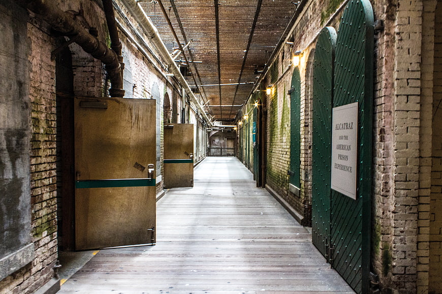 Alcatraz Prison Corridor with Green Cell Doors and Brick Walls