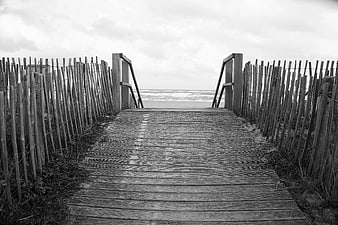 Black and White Wooden Boardwalk Leading to Ocean Beach