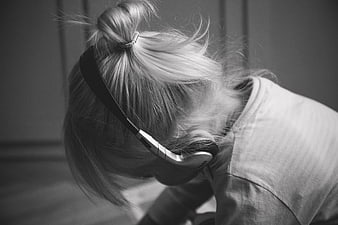Black and white photo of a child wearing headphones
