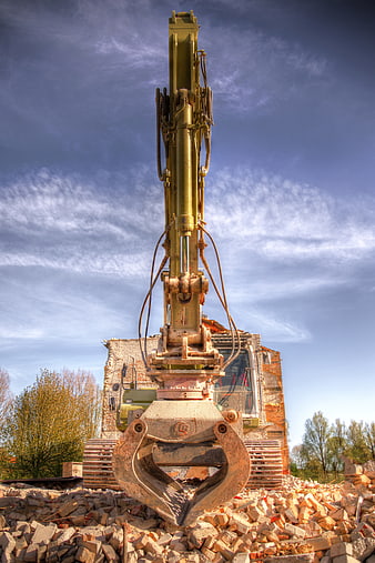 Yellow Excavator with Claw on Demolition Site
