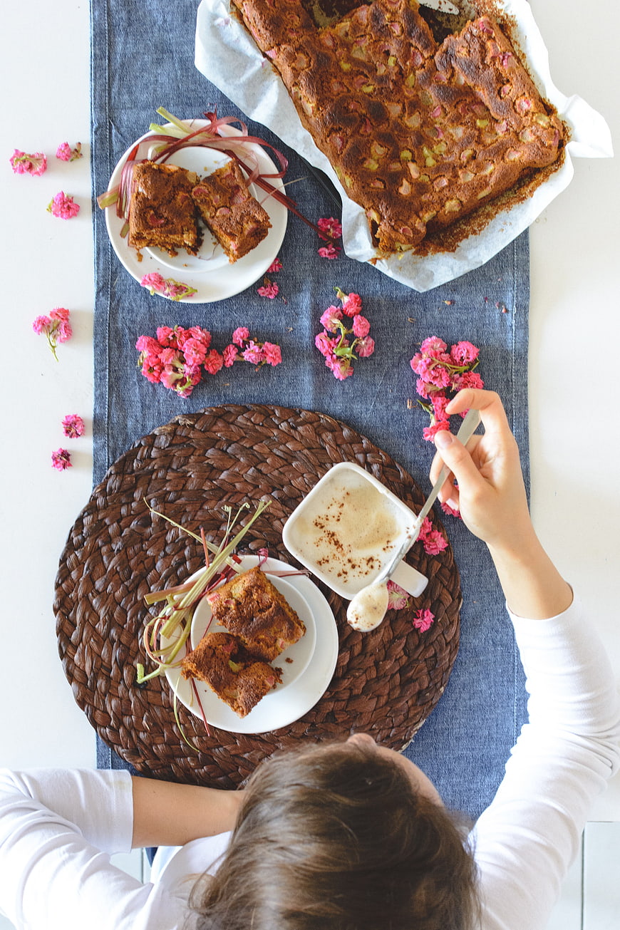 Overhead view of homemade rhubarb cake and coffee on table