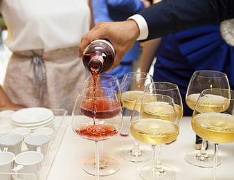 Pouring Rosé Wine into Glasses at a Catering Event