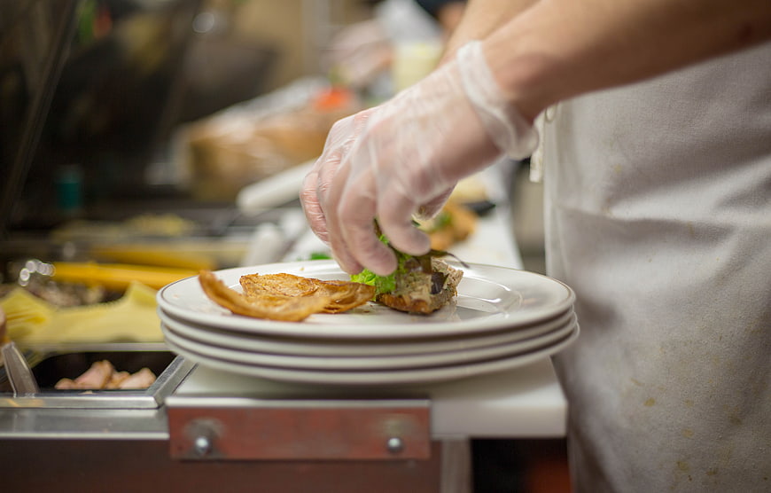 Chef Plating Gourmet Food in Professional Kitchen