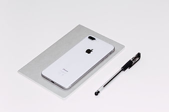 White iPhone and Pen on Minimalist Background