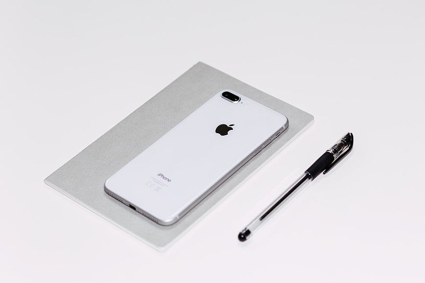 White iPhone and Pen on Minimalist Background