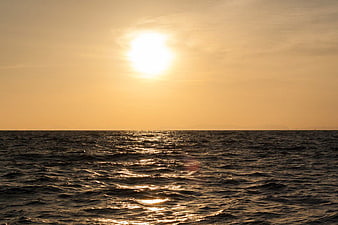 Golden Sunset Over Ocean with Sparkling Water Reflections