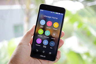 Hand holding smartphone displaying home screen settings
