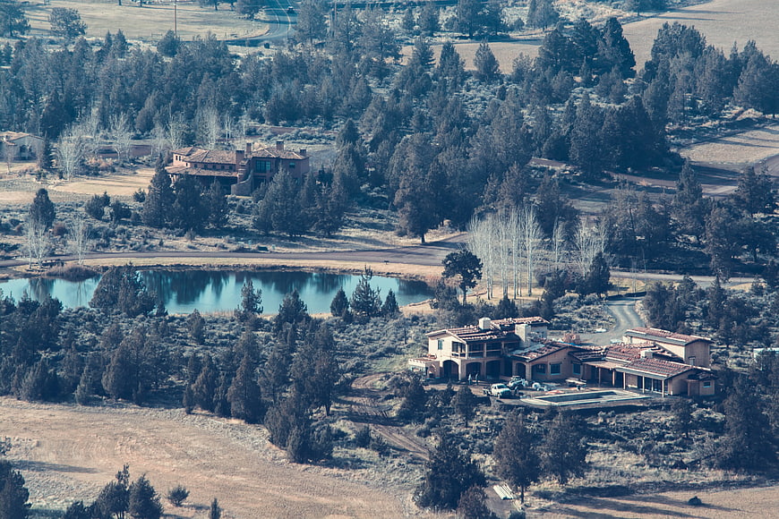 Aerial View of Luxury Estate Near Lake and Forest
