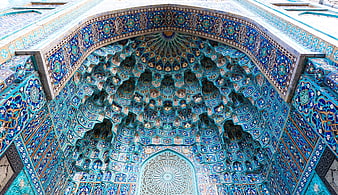 Intricate Blue Tilework And Muqarnas Vaulting In Islamic Mosque Architecture