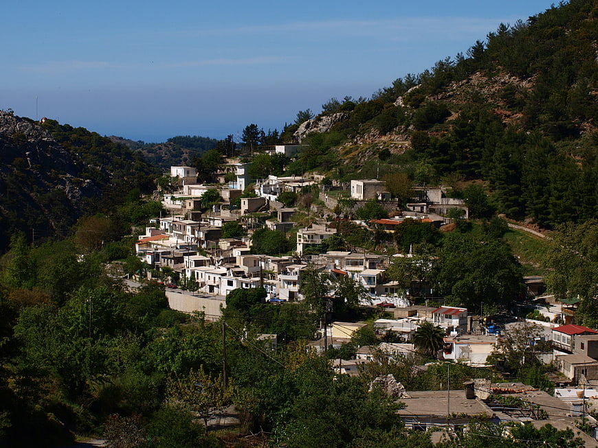 Hillside village in Crete with white houses and green mountains