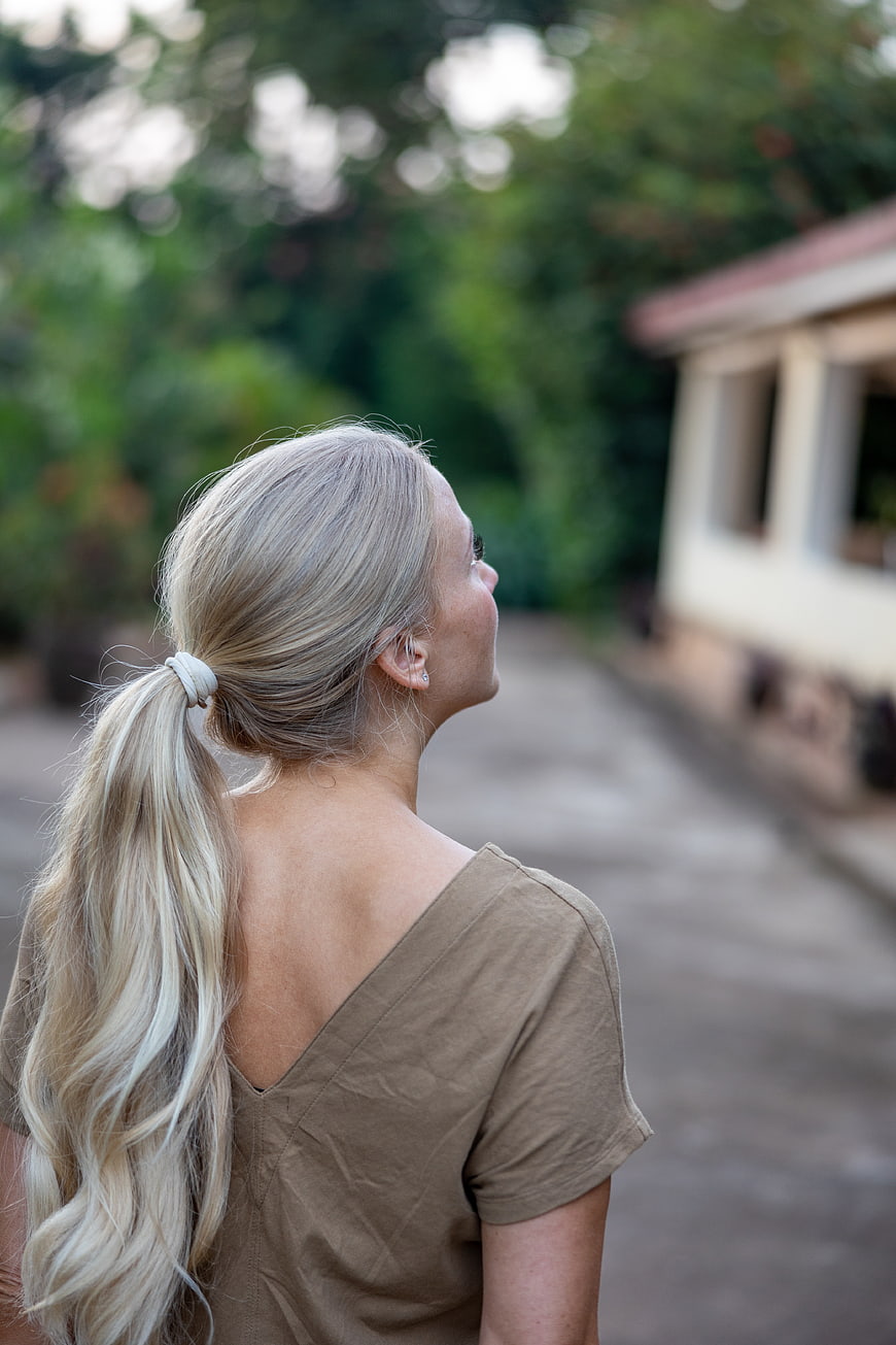 Blonde Woman Looking Up Outdoors in Nature