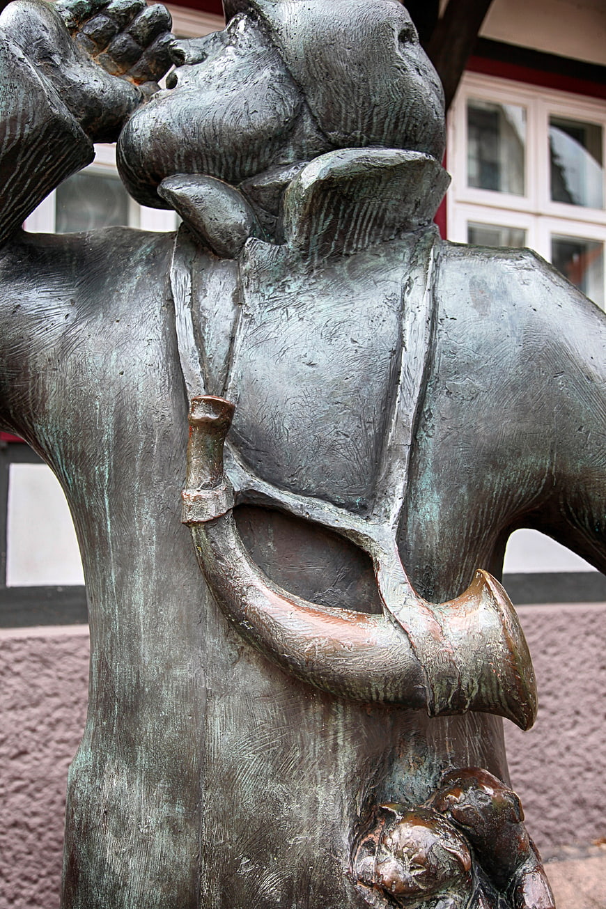 Close-up of bronze night watchman statue with horn