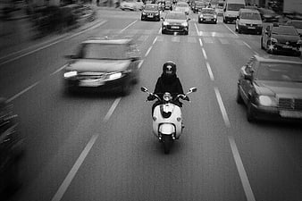 Motorcyclist on Scooter in City Traffic Black and White
