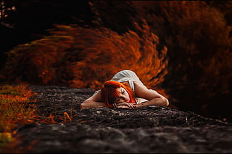 Redhead Woman Sleeping on Dark Path in Autumn Forest