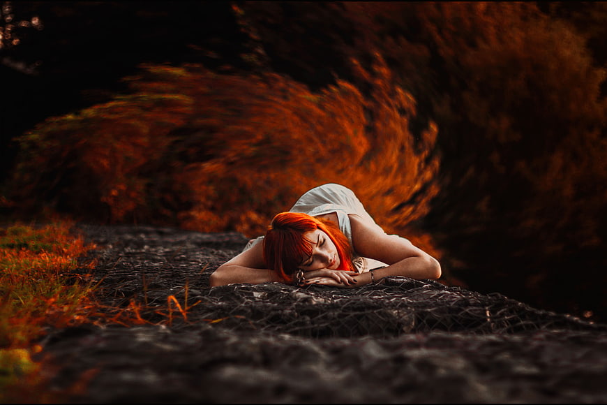 Redhead Woman Sleeping on Dark Path in Autumn Forest