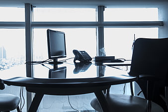Silhouette of modern office desk with computer and city view