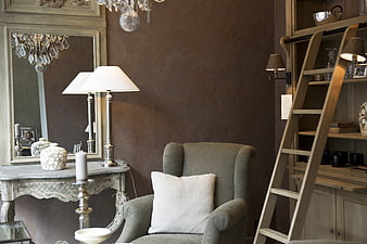 Elegant Interior Design With Armchair, Ladder Shelf, And Decorative Mirror