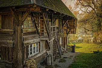 Rustic wooden barn with external staircase in autumn countryside