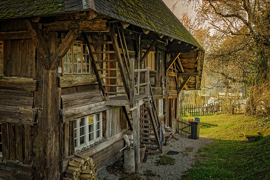 Rustic wooden barn with external staircase in autumn countryside